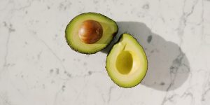 an avocado sliced in half on a counter