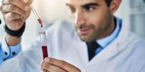 doctor holding a vial of blood