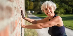 older woman stopping during a jog