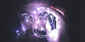 man holding lights in the shape of a brain